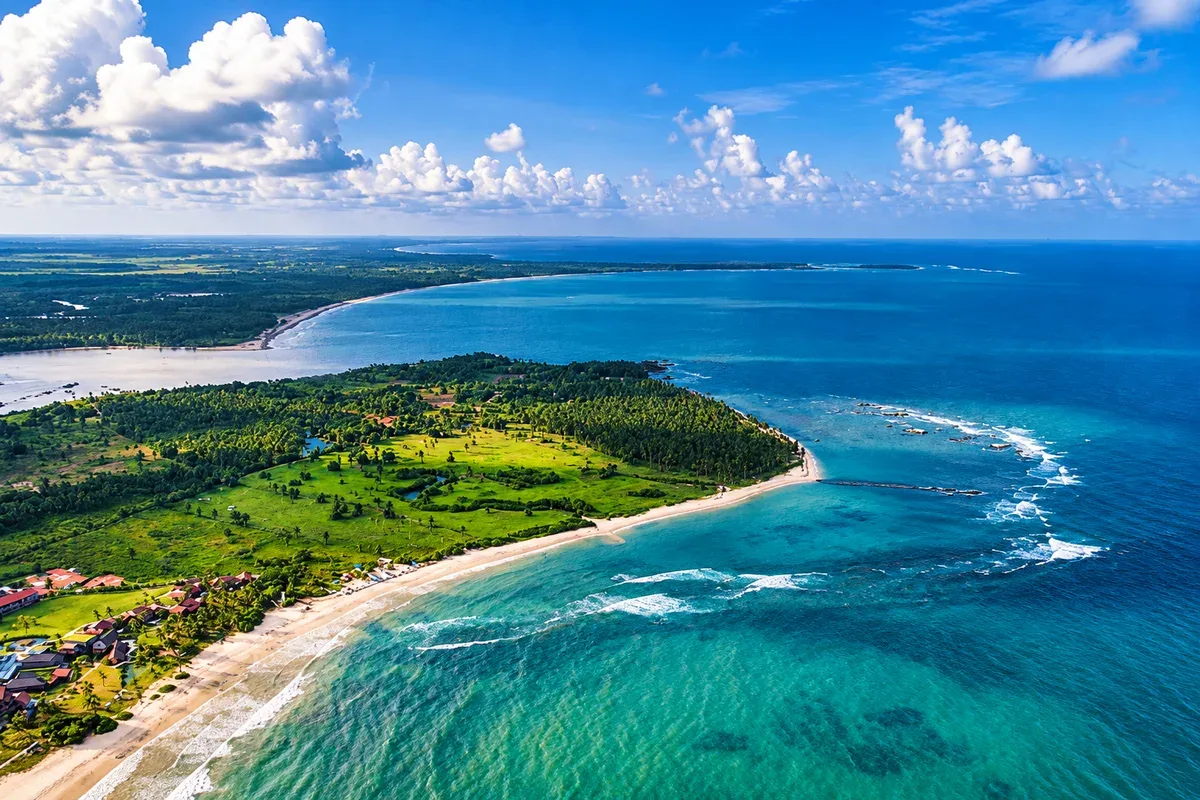 Aerial view of sandy bays, palms and blue ocean around Pasikudah