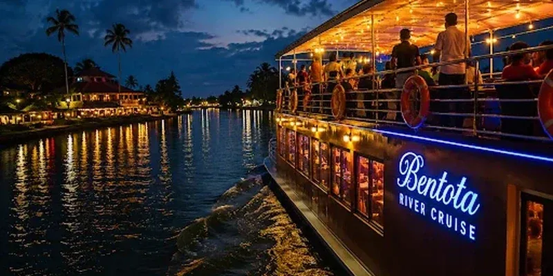 An illuminated Bentota river cruise boat on the water at dusk