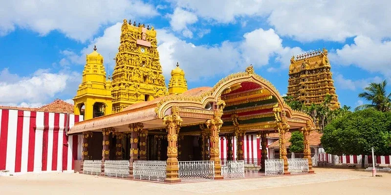 Ornate golden temple towers and red-and-white striped walls in Jaffna