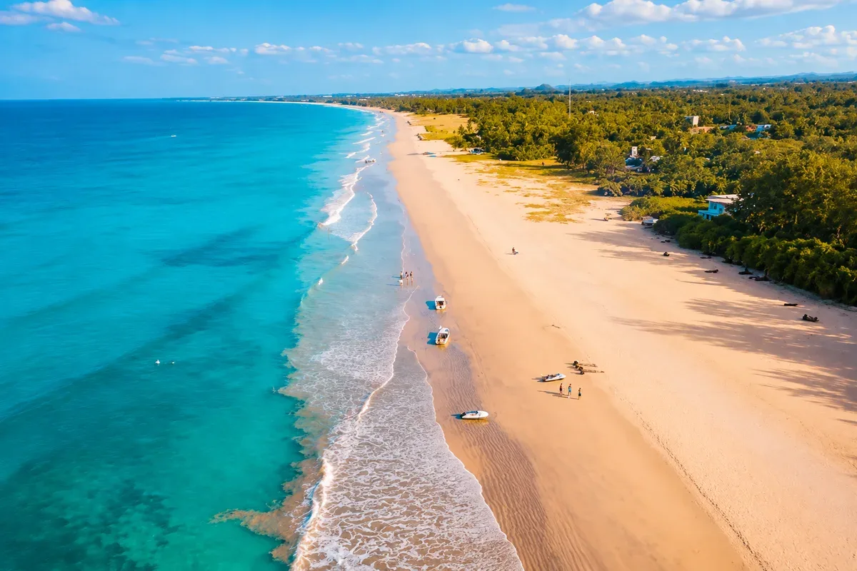Aerial view of a sandy beach and blue sea along the Trincomalee coast