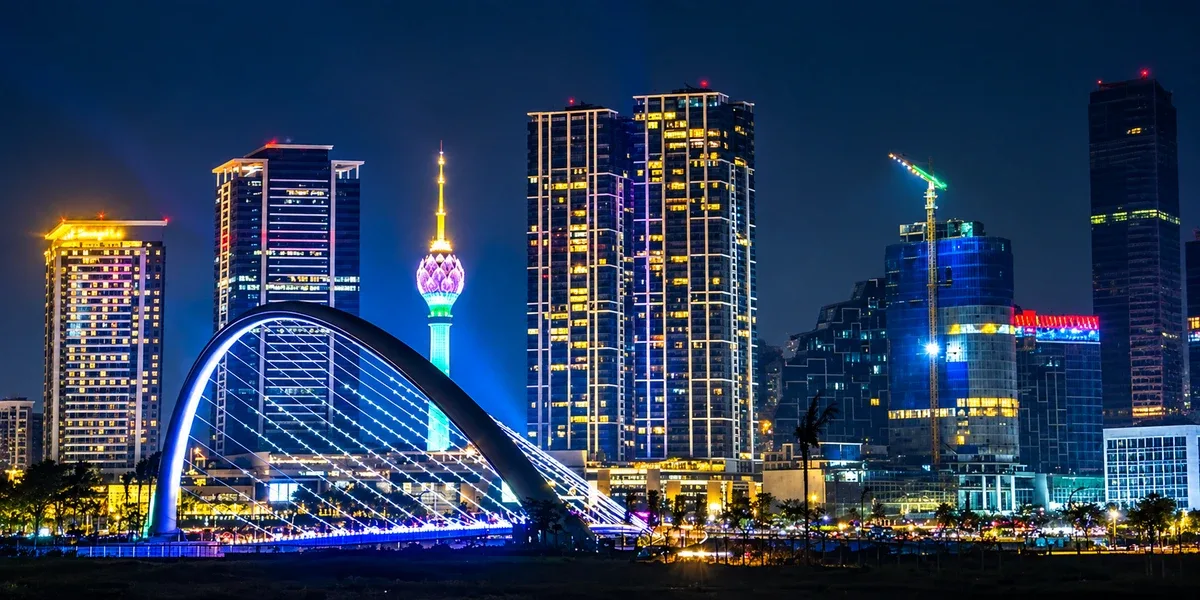 Colombo skyline at night with the illuminated Lotus Tower and waterfront bridge