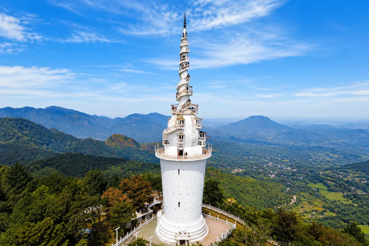 The white spiral tower at Ambuluwawa above the surrounding hills